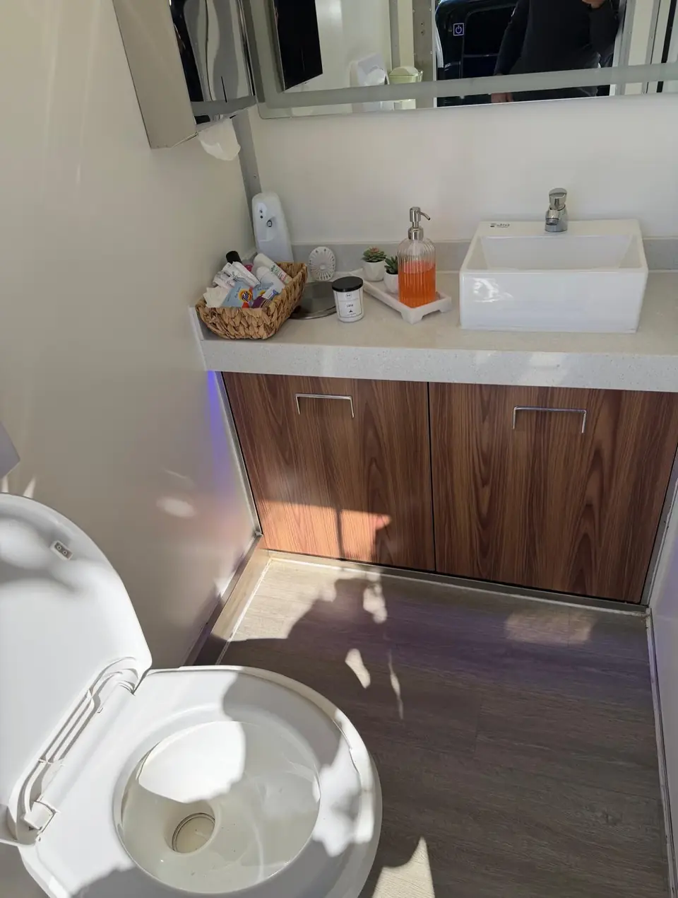 Vanity sink and amenities inside a restroom trailer.