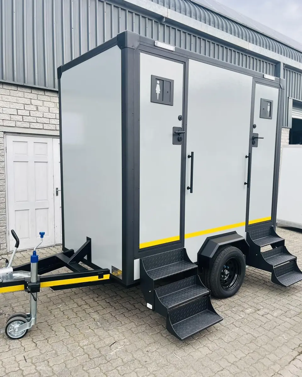 White two-door restroom trailer with folding steps